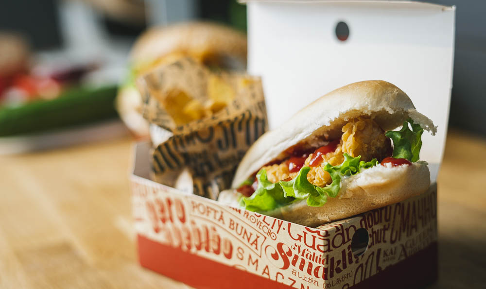 un perrito caliente con pollo en una caja